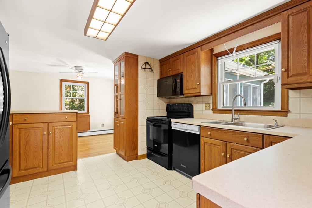19 Ronald Road Arlington, MA 02474 - Photo 9 of 28 a kitchen with stainless steel appliances a sink stove and a refrigerator