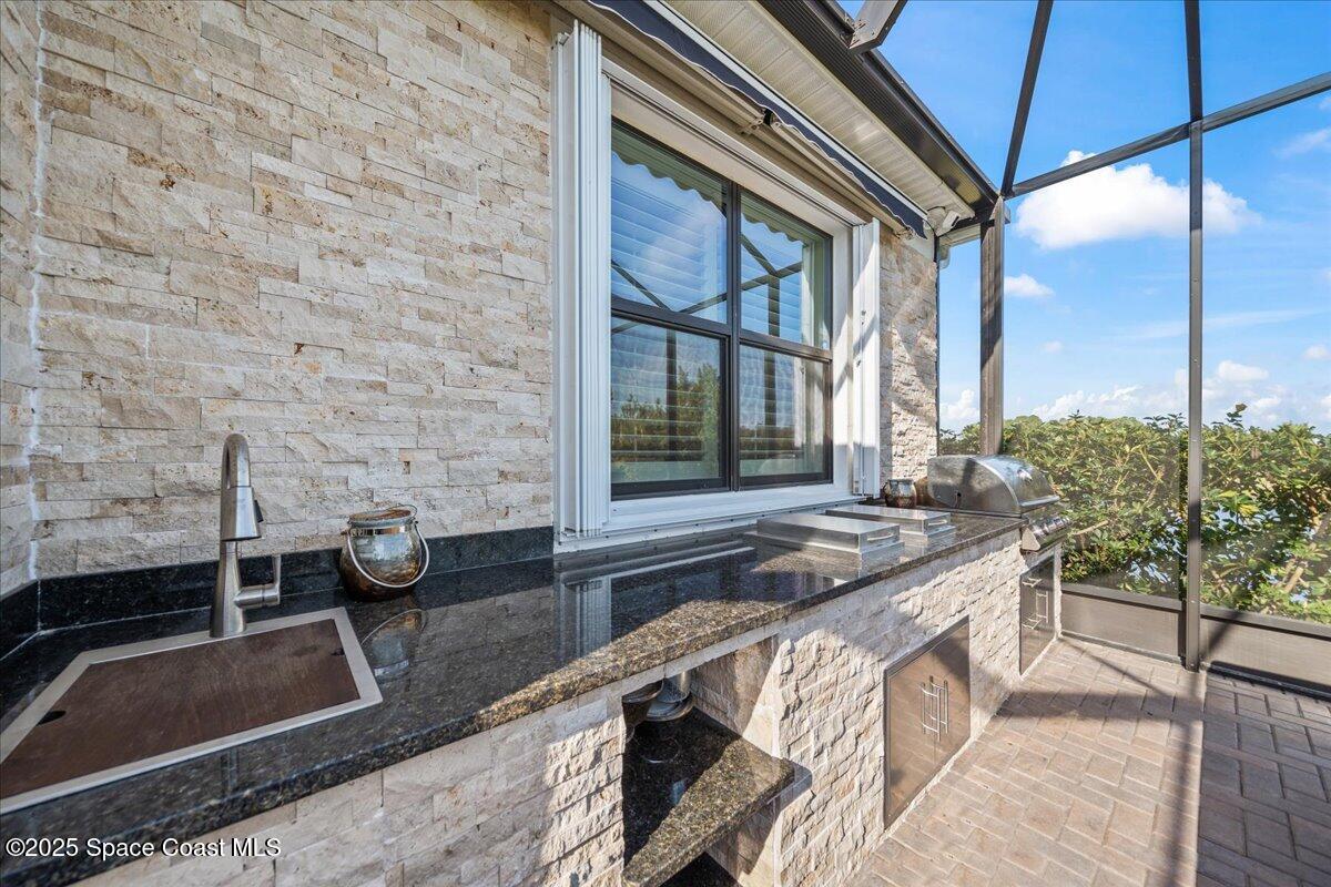 2190 Caravan Place Melbourne, FL 32940 - Photo 16 of 46 a bathroom with a granite countertop sink and a large mirror