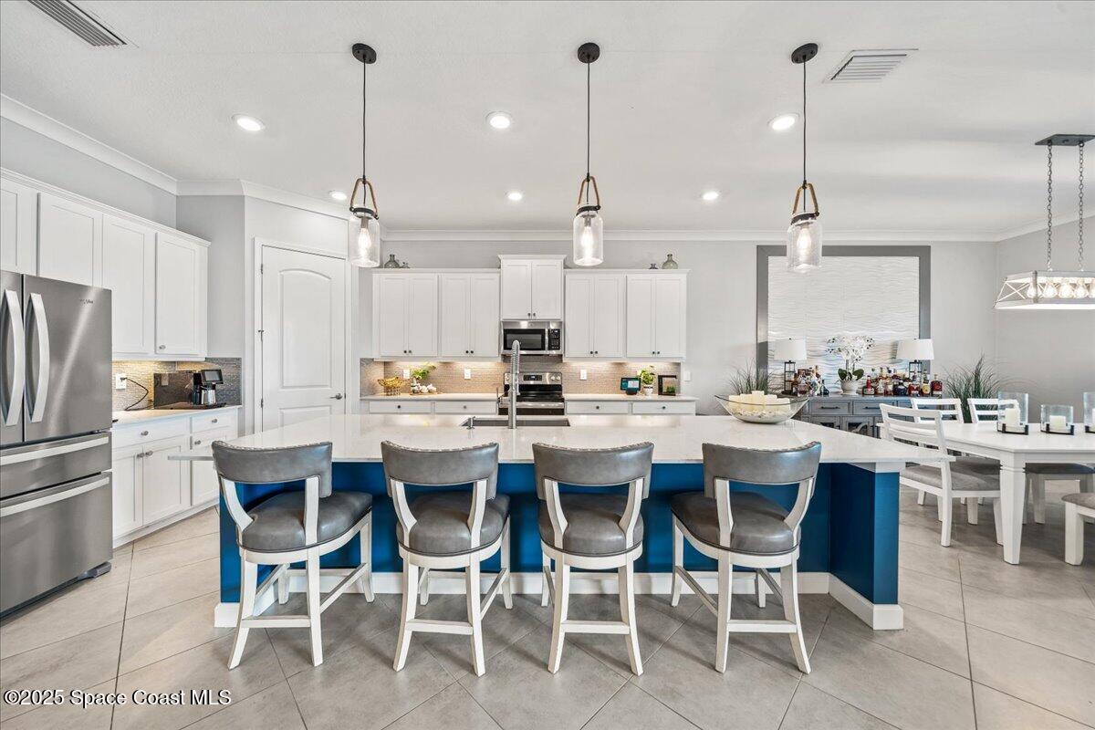 2190 Caravan Place Melbourne, FL 32940 - Photo 18 of 46 a large kitchen with a table and chairs