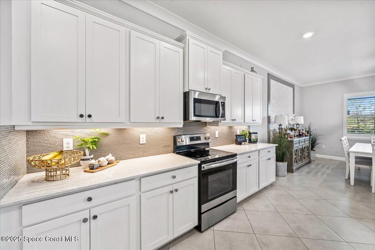 2190 Caravan Place Melbourne, FL 32940 - Photo 20 of 46 a kitchen with white cabinets and sink