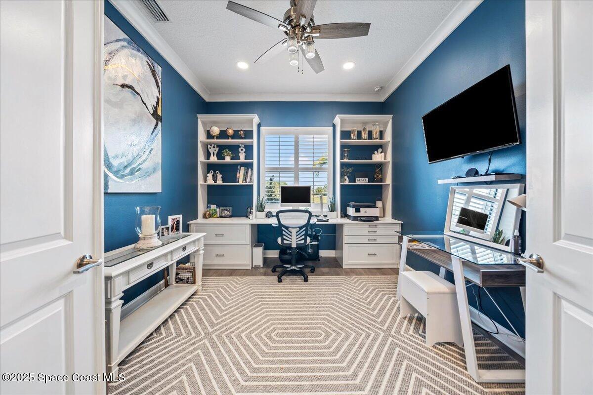 2190 Caravan Place Melbourne, FL 32940 - Photo 23 of 46 a living room with furniture a flat screen tv and a fireplace