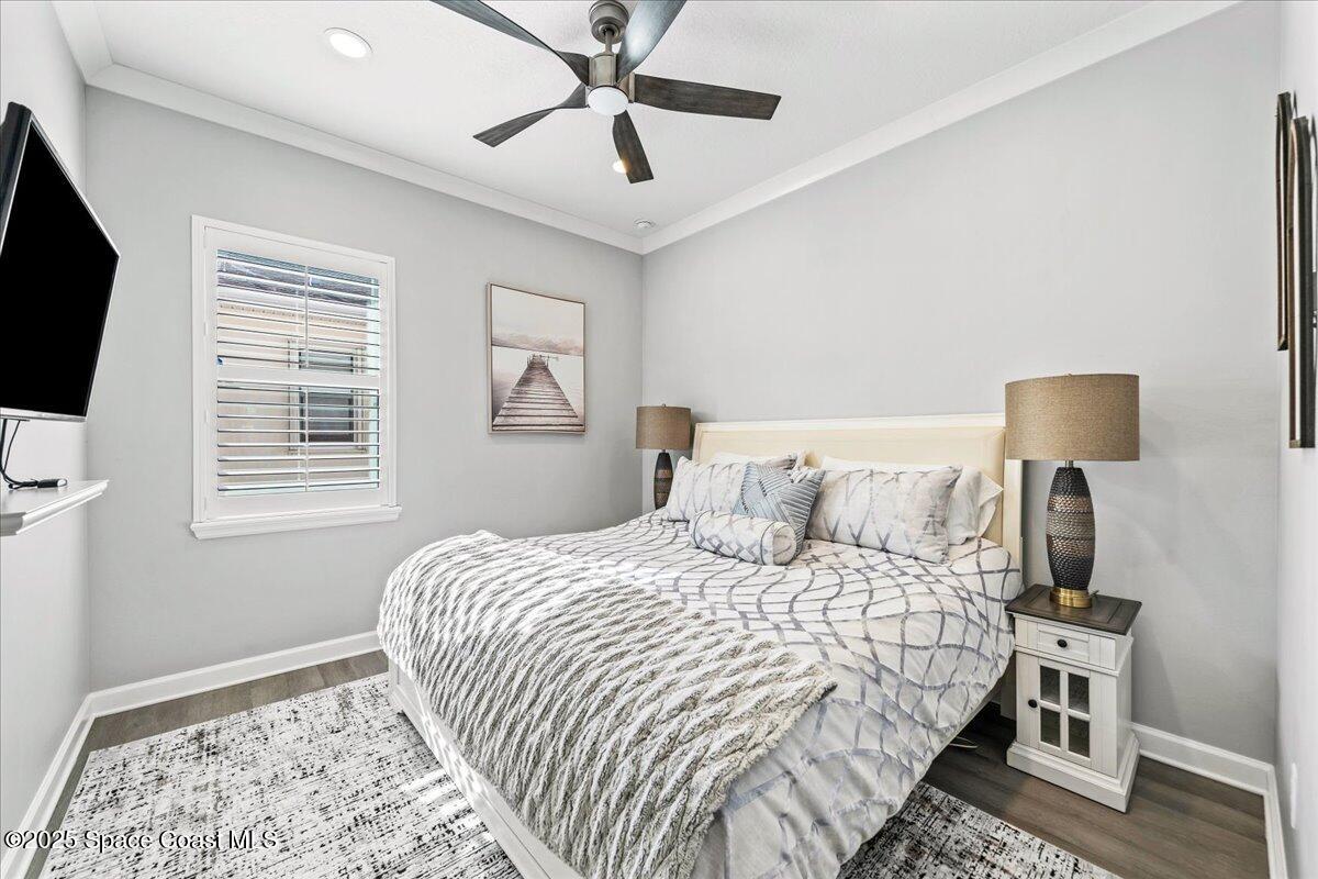 2190 Caravan Place Melbourne, FL 32940 - Photo 31 of 46 a bedroom with a bed a flat screen tv and a window