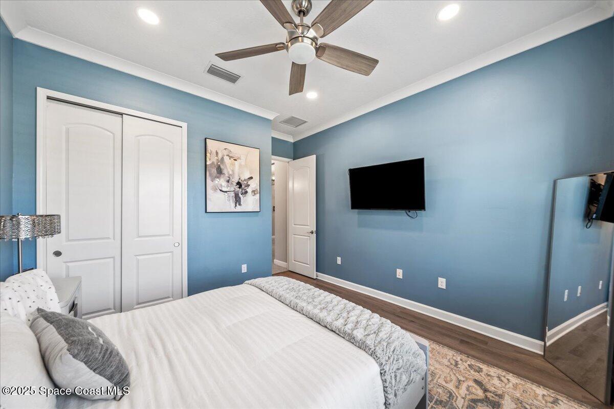 2190 Caravan Place Melbourne, FL 32940 - Photo 36 of 46 a bedroom with a bed and a flat screen tv