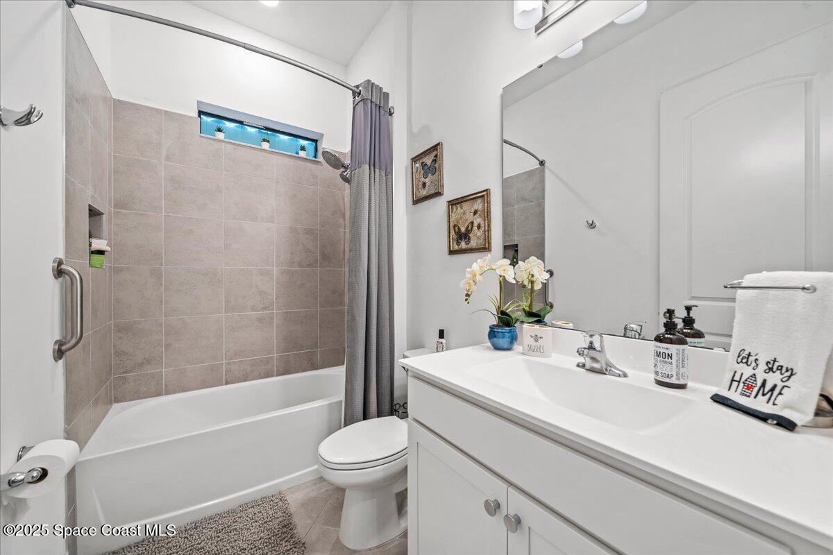 2190 Caravan Place Melbourne, FL 32940 - Photo 37 of 46 a bathroom with a sink a toilet and a bathtub