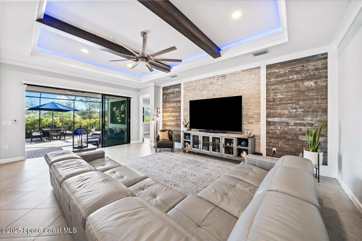2190 Caravan Place Melbourne, FL 32940 - Photo 4 of 46 a living room with furniture and a flat screen tv