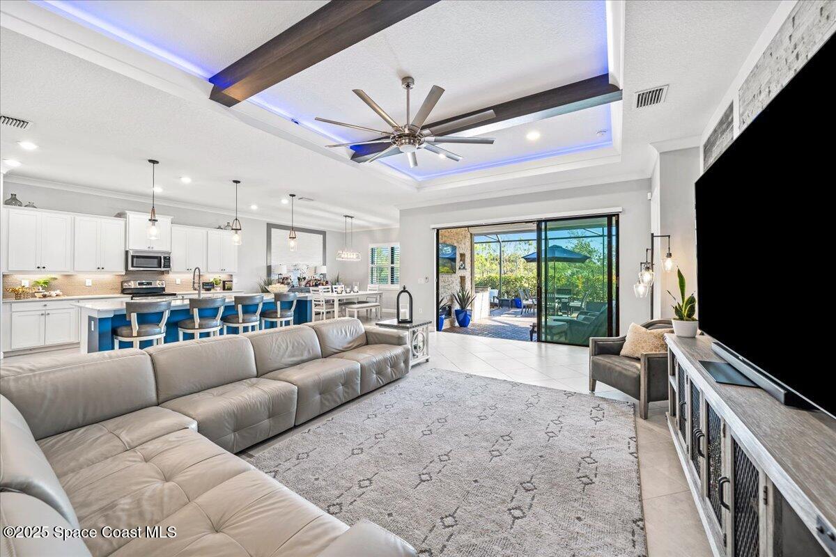 2190 Caravan Place Melbourne, FL 32940 - Photo 6 of 46 a living room with furniture and a flat screen tv