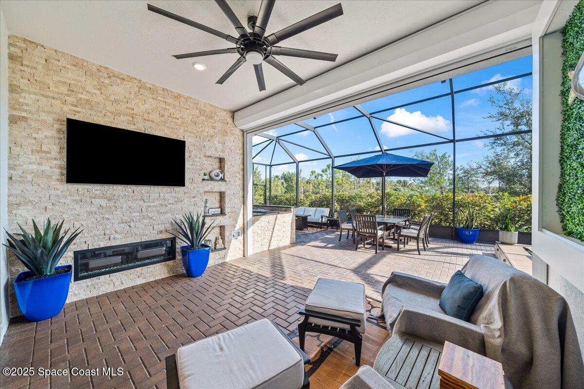 2190 Caravan Place Melbourne, FL 32940 - Photo 7 of 46 a outdoor space with patio the couches and a dining table with garden view