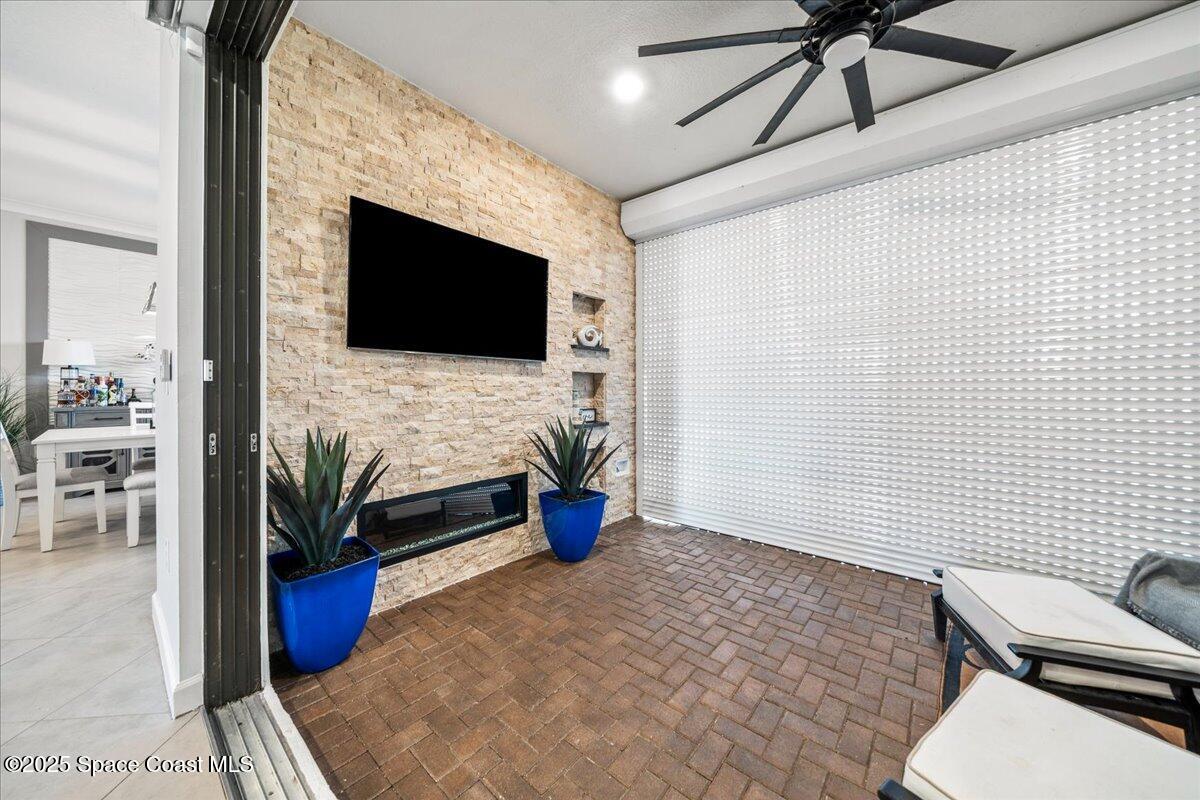 2190 Caravan Place Melbourne, FL 32940 - Photo 8 of 46 a living room with furniture and a flat screen tv