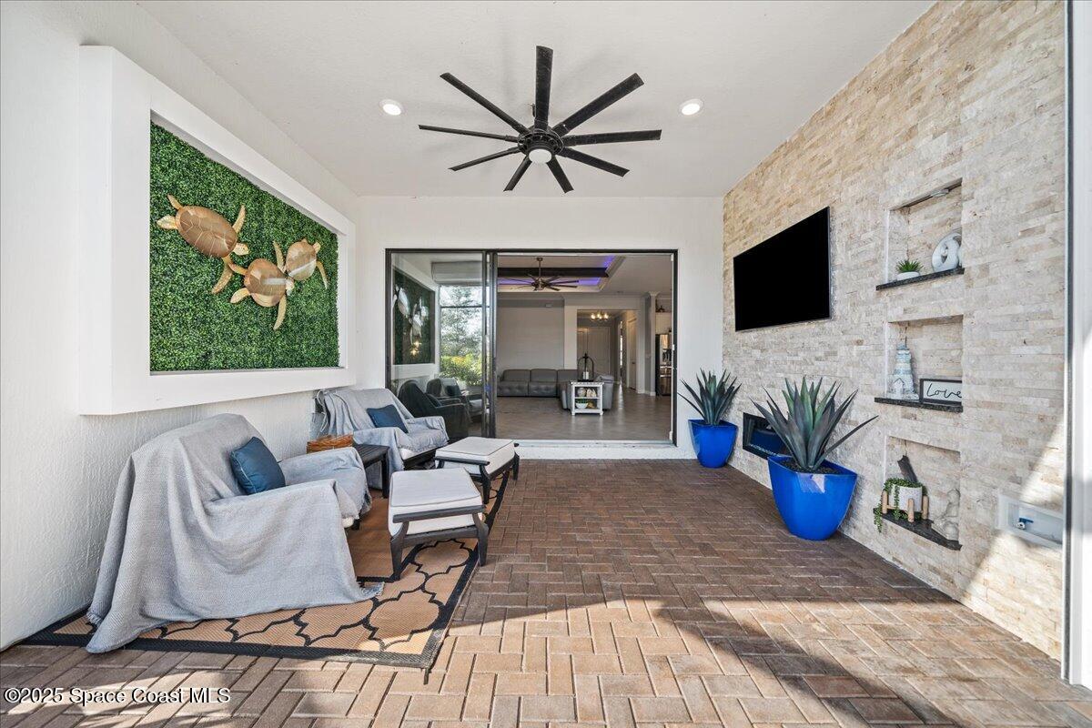 2190 Caravan Place Melbourne, FL 32940 - Photo 10 of 46 a living room with furniture a fireplace and a flat screen tv