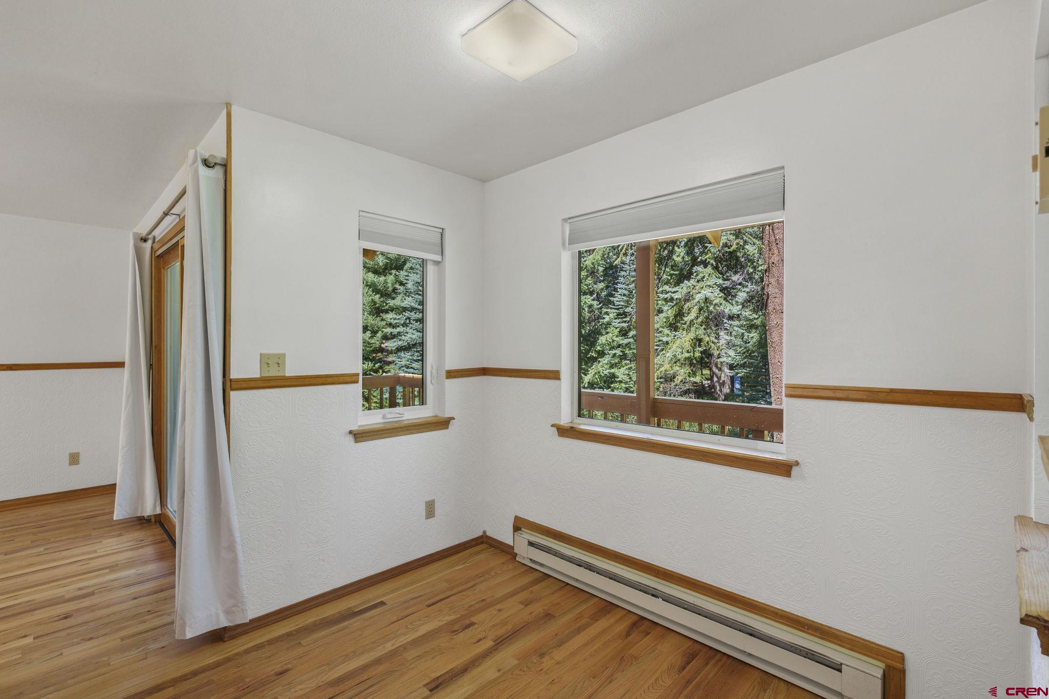 37 Verde Lane Durango, CO 81301 - Photo 22 of 45 a view of an empty room with wooden floor and a window