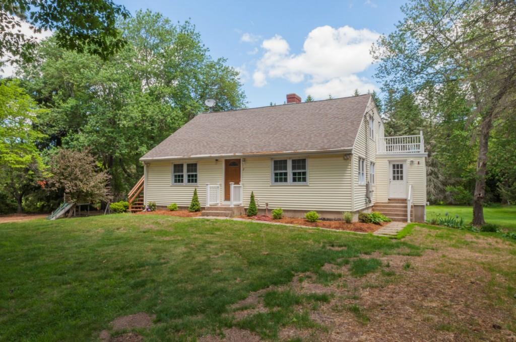 2 Castle Road Tolland, CT 06084 - Photo 1 of 1 a front view of a house with a yard and trees