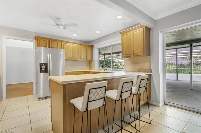 a kitchen with stainless steel appliances granite countertop a sink and a refrigerator