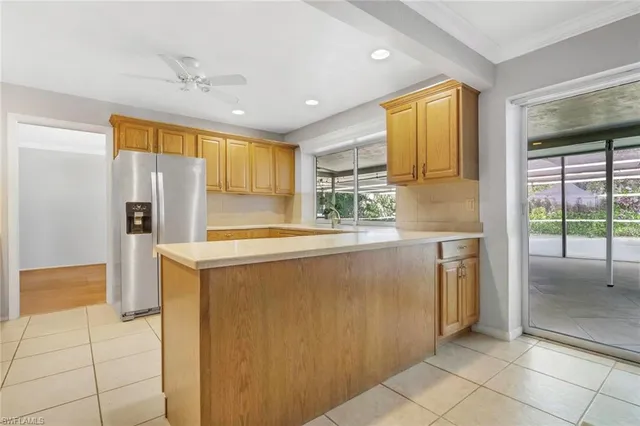 a kitchen with stainless steel appliances granite countertop a refrigerator and a sink