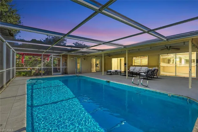 a view of house with backyard porch and sitting area