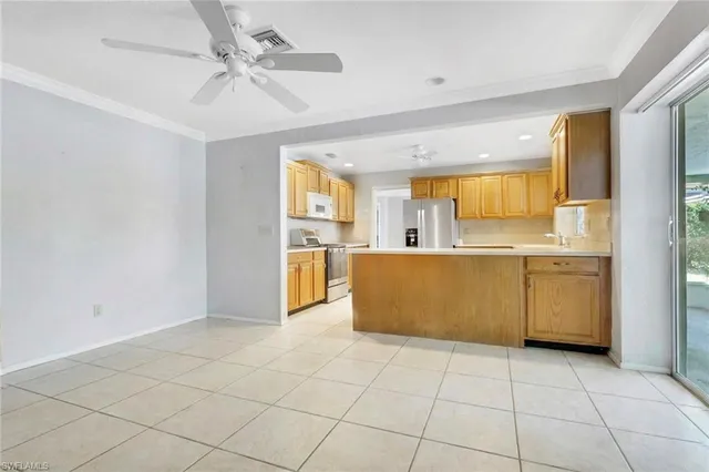 a view of a kitchen with a sink and a refrigerator