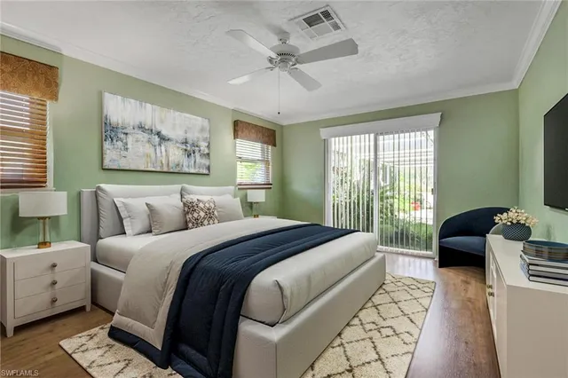 a spacious bedroom with a bed and glass door