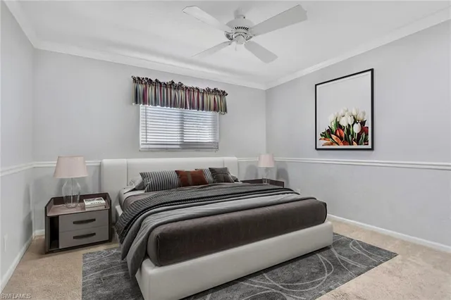 a bedroom with a bed and a painting on the wall