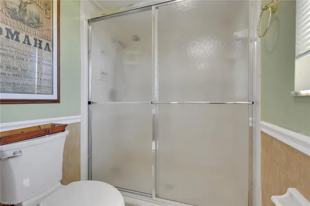 a white toilet sitting next to a bathroom sink