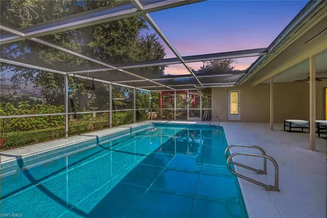 a view of a room with wooden floor and windows