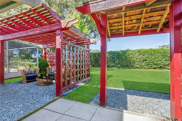 a view of a backyard with plants and wooden fence