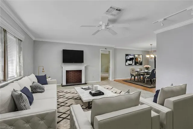 a living room with furniture a fireplace and a flat screen tv