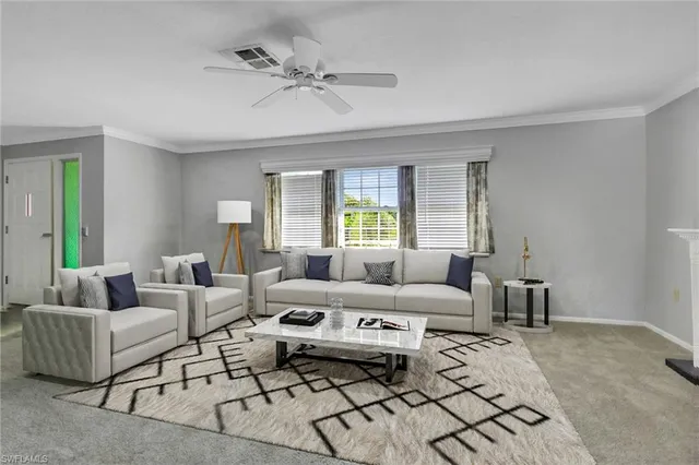 a bedroom with furniture and a large window