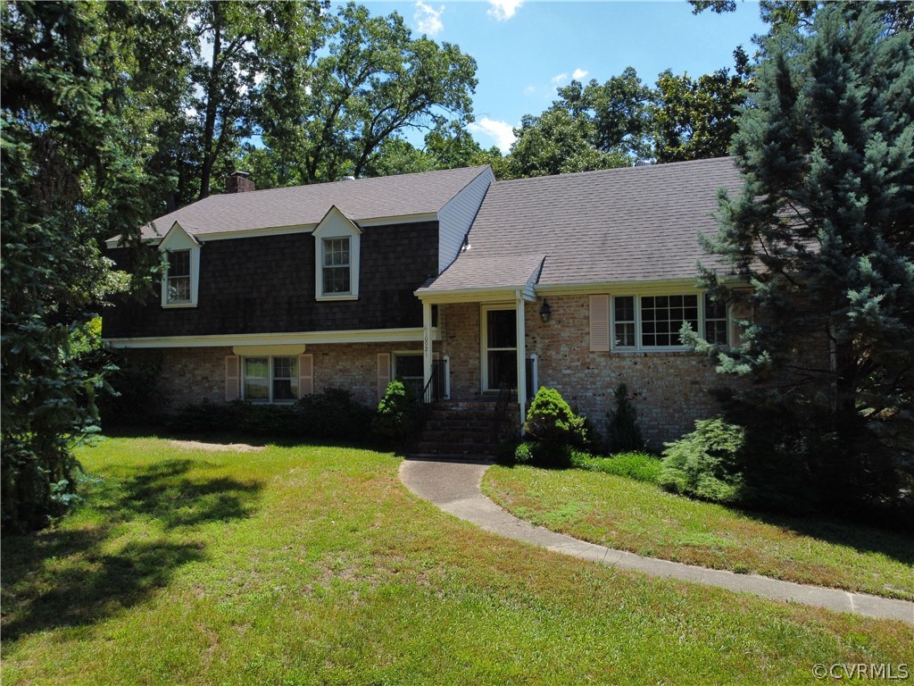 10921 Stepney Road Chester, VA 23831 - Photo 1 of 34 a front view of a house with a yard and garage