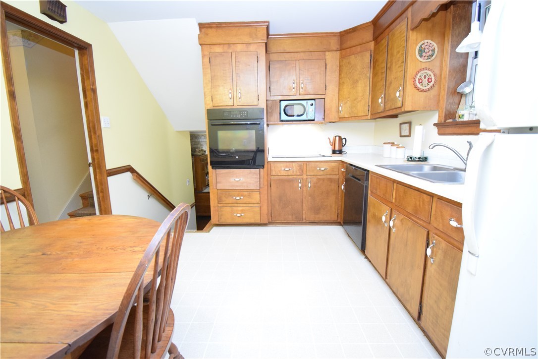 10921 Stepney Road Chester, VA 23831 - Photo 18 of 34 a kitchen with stainless steel appliances granite countertop a sink and a stove top oven