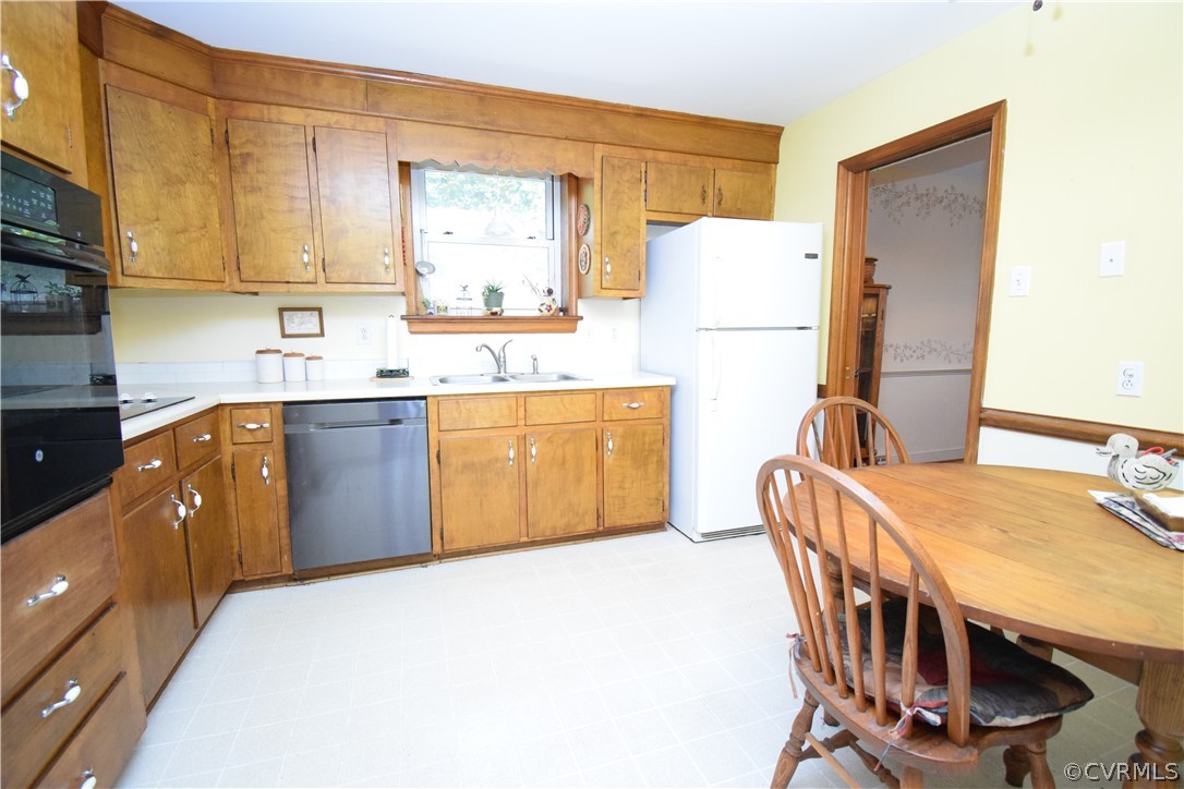 10921 Stepney Road Chester, VA 23831 - Photo 19 of 34 a kitchen with stainless steel appliances a table and chairs