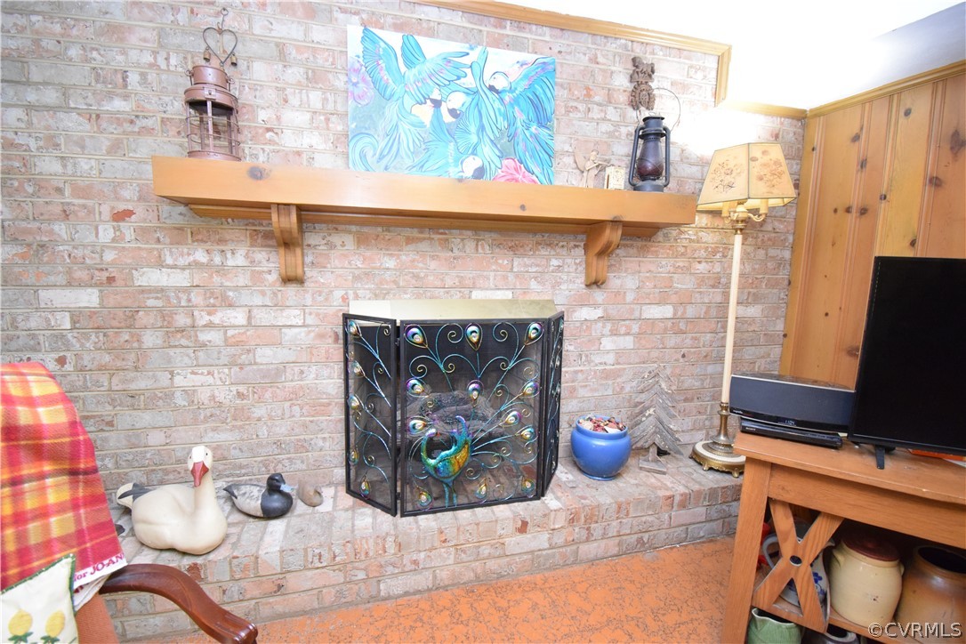 10921 Stepney Road Chester, VA 23831 - Photo 23 of 34 a dining room with a fireplace and a table