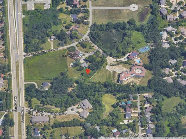 an aerial view of residential houses with outdoor space