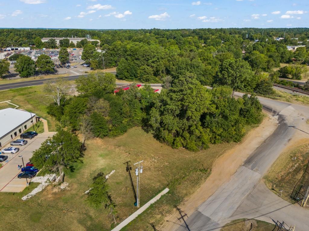 3208 West Loop 281 Longview, TX 75604 - Photo 9 of 18 Expansive parcel featuring a verdant landscape with mature trees and direct access to paved roads