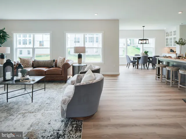 a kitchen with stainless steel appliances kitchen island granite countertop a stove refrigerator and cabinets