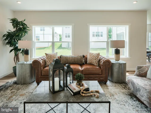 a living room with furniture potted plant and a window
