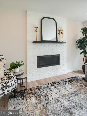 a view of a room with wooden floor chandelier and a window