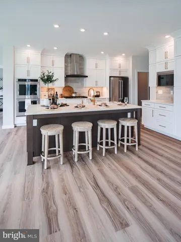 an empty room with wooden floor fireplace and windows