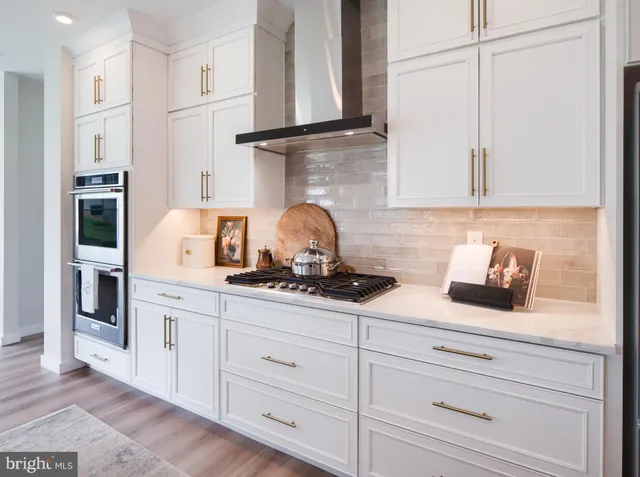 a spacious bathroom with a double vanity sink a mirror and a bathtub
