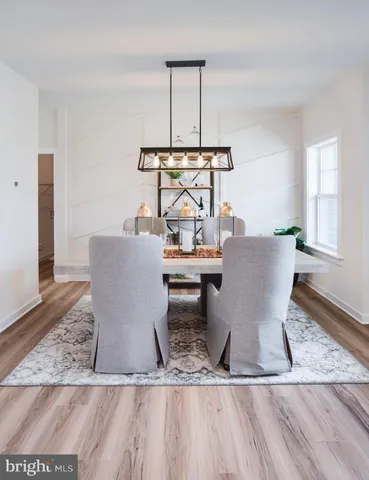a living room with furniture a wooden floor and a large window