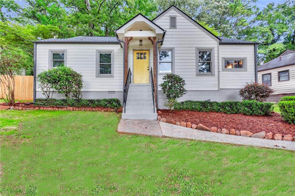 1874 Ridgeland Drive Decatur, GA 30032 - Photo 1 of 1 a front view of a house with a garden