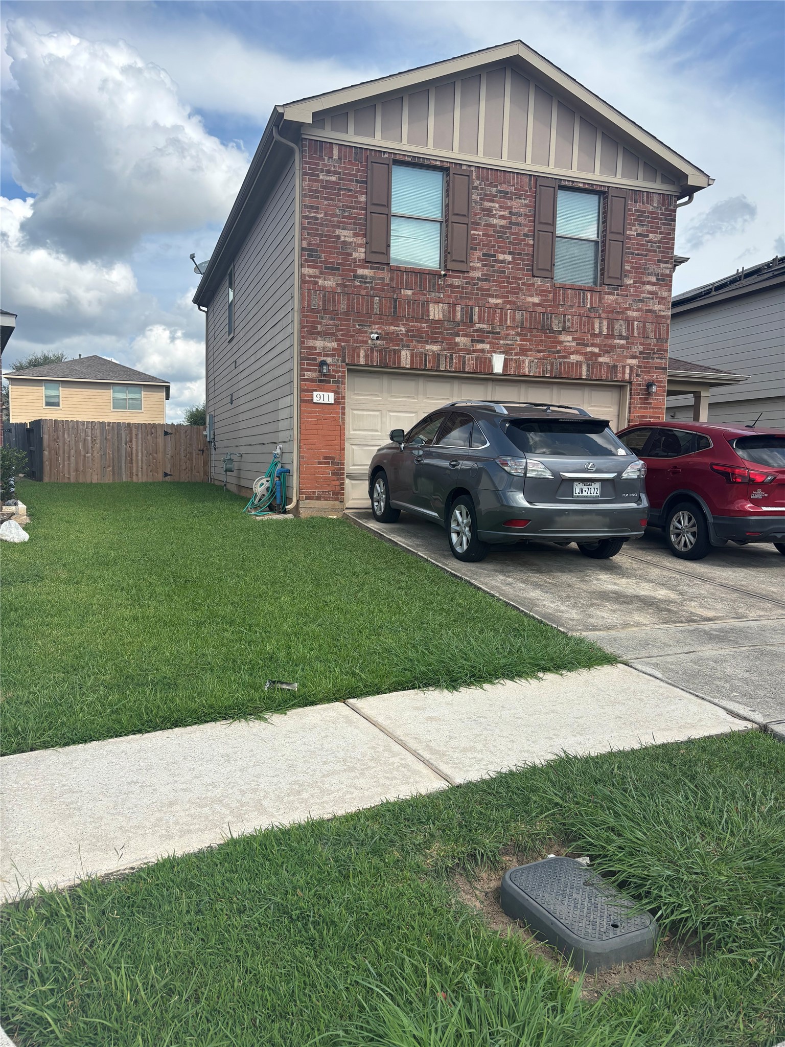 911 Belshear Court Houston, TX 77073 - Photo 1 of 21 a front view of a house with a garden and parking space