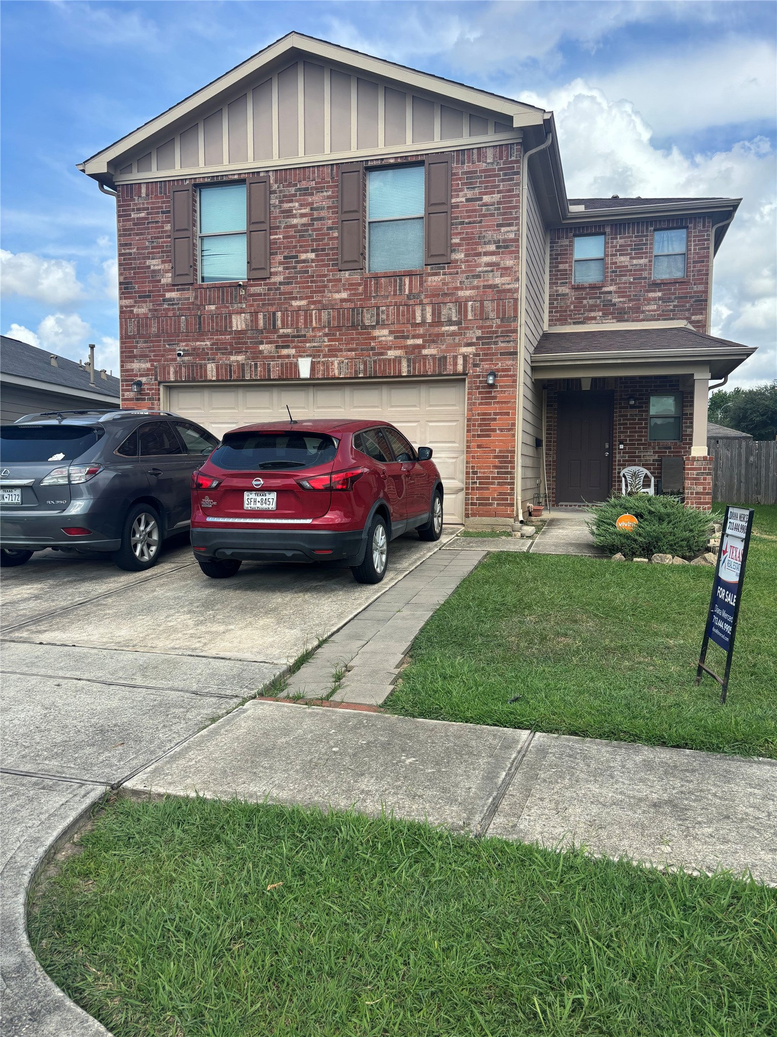 911 Belshear Court Houston, TX 77073 - Photo 2 of 21 a front view of a house with a garden and parking space