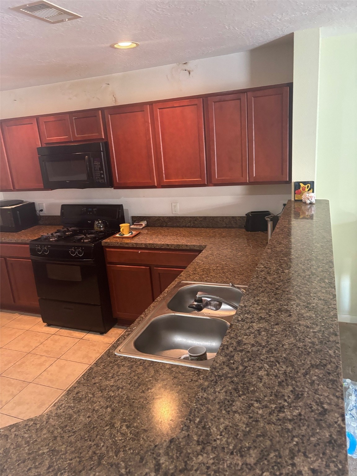 911 Belshear Court Houston, TX 77073 - Photo 9 of 21 a kitchen with a sink a stove and cabinets