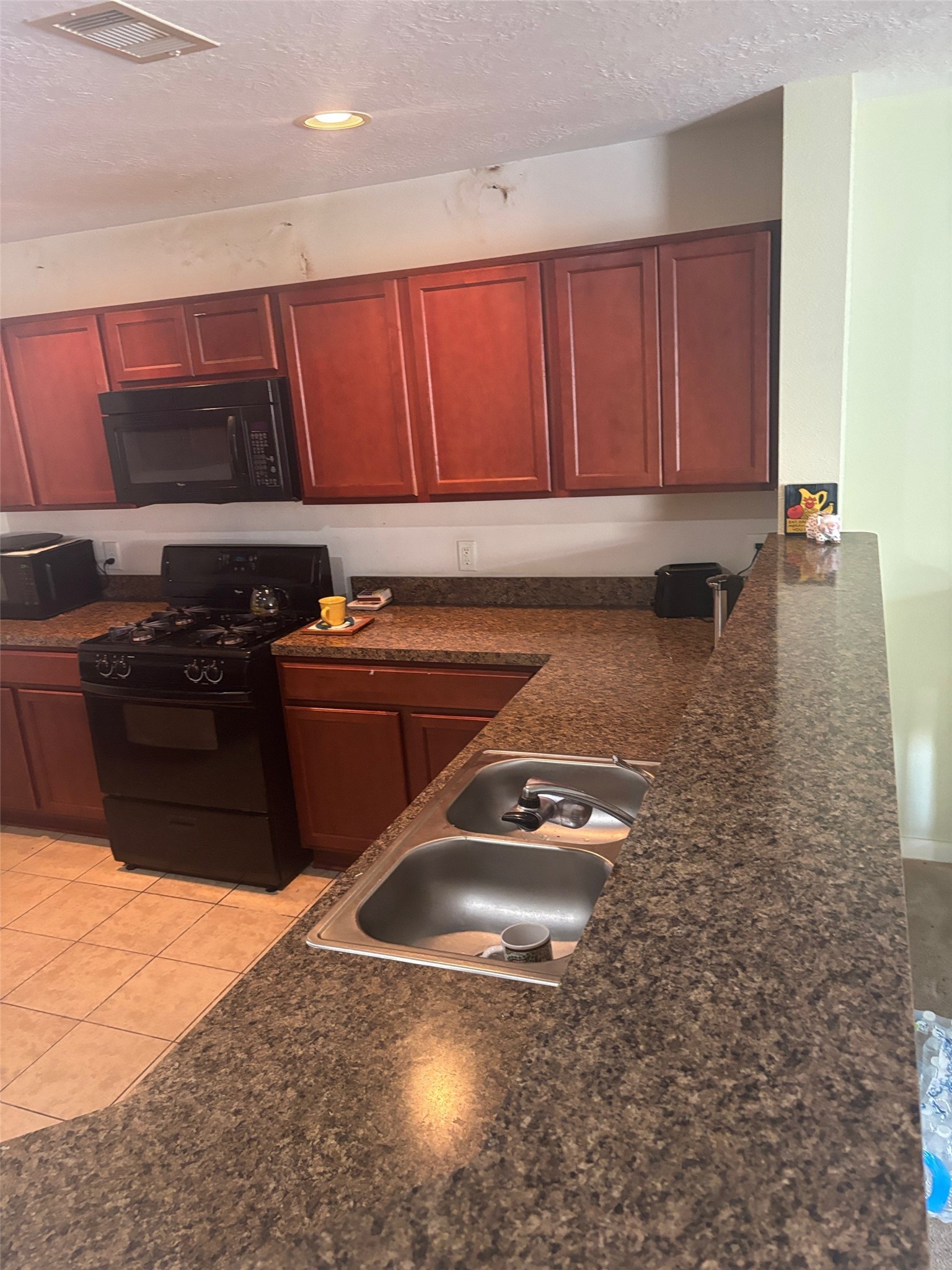 911 Belshear Court Houston, TX 77073 - Photo 9 of 21 a kitchen with a sink a stove and cabinets