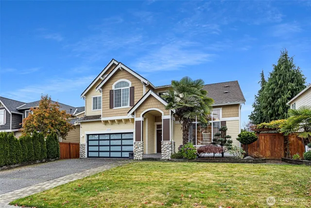 a front view of a house with a yard