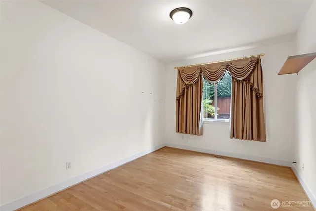 a view of an empty room and a window