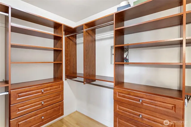 a view of walk in closet with empty racks