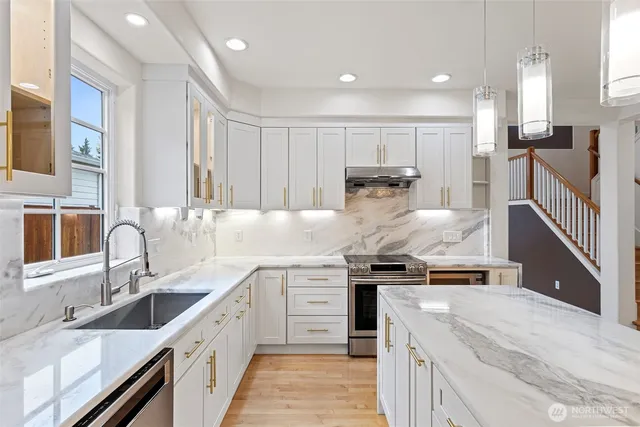 a kitchen with a sink stove and cabinets