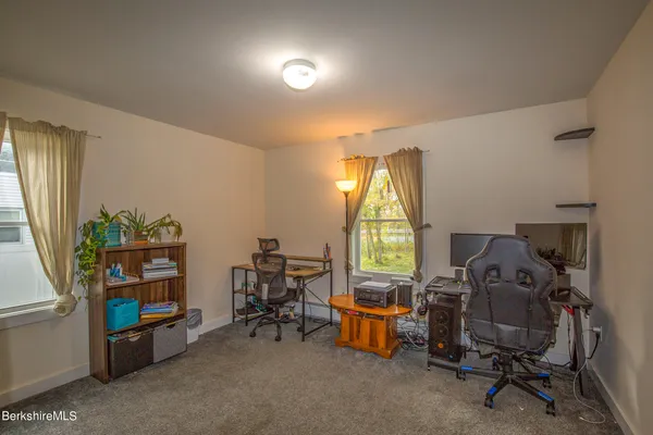 a view of a workspace with furniture and a window