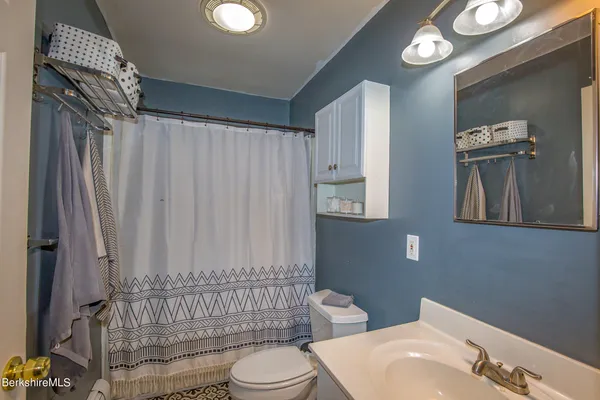 a bathroom with a toilet a sink and bathtub