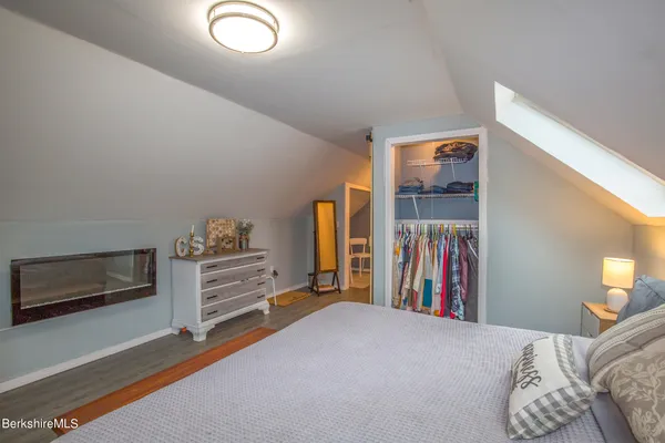 a view of a bedroom with furniture and closet